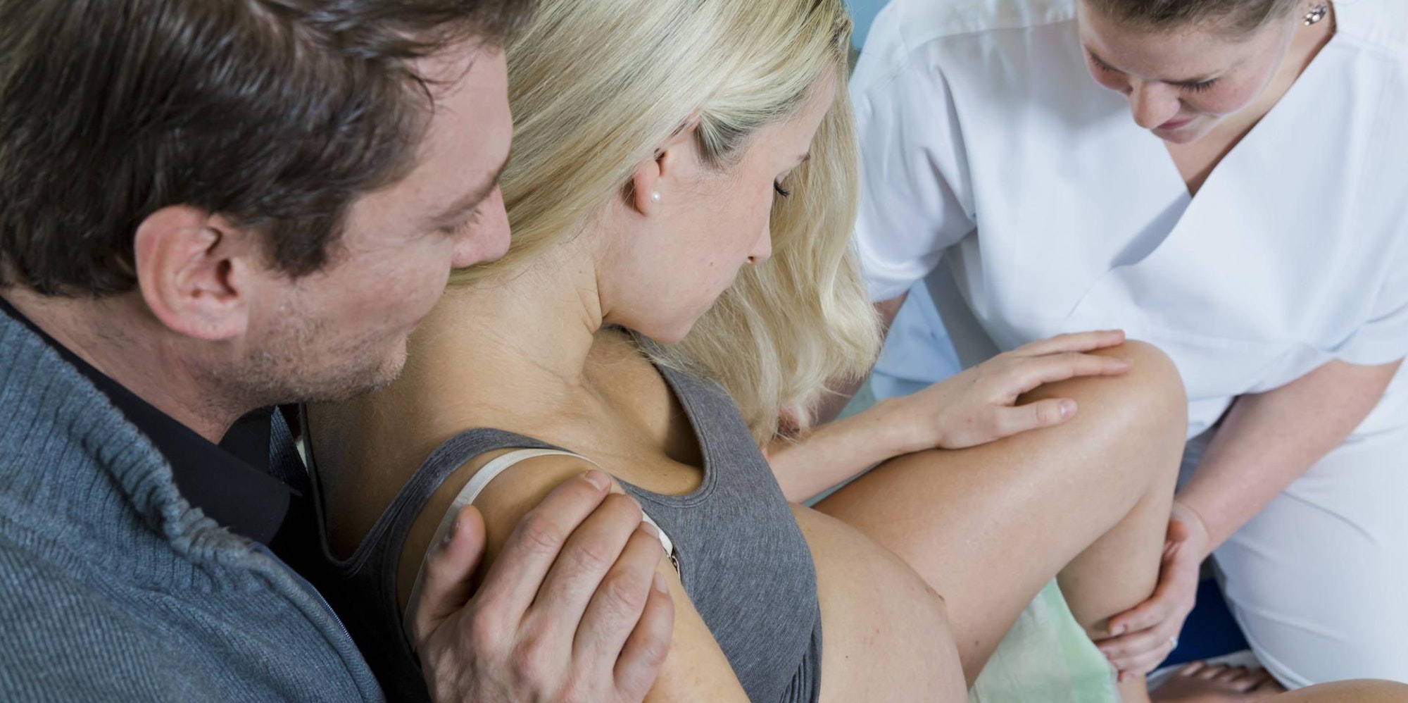 Ein Paar und eine Ärztin während der Geburt