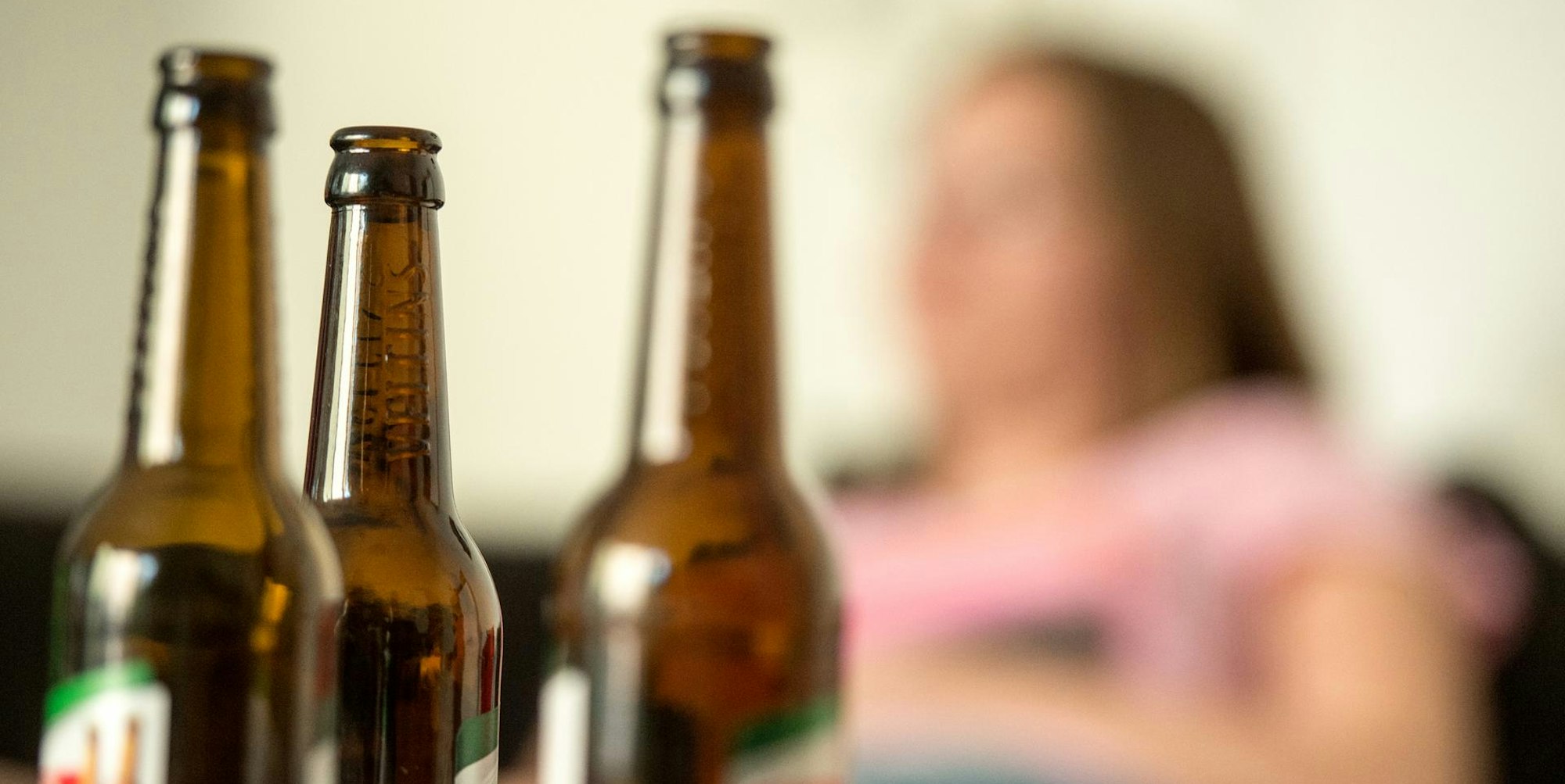 Frau mit Bierflaschen im Vordergrund