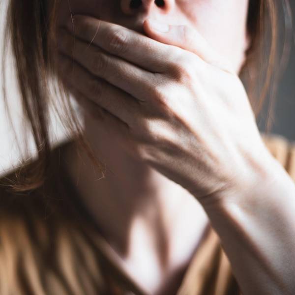 Eine Frau hält geschockt die Hand vor den Mund.