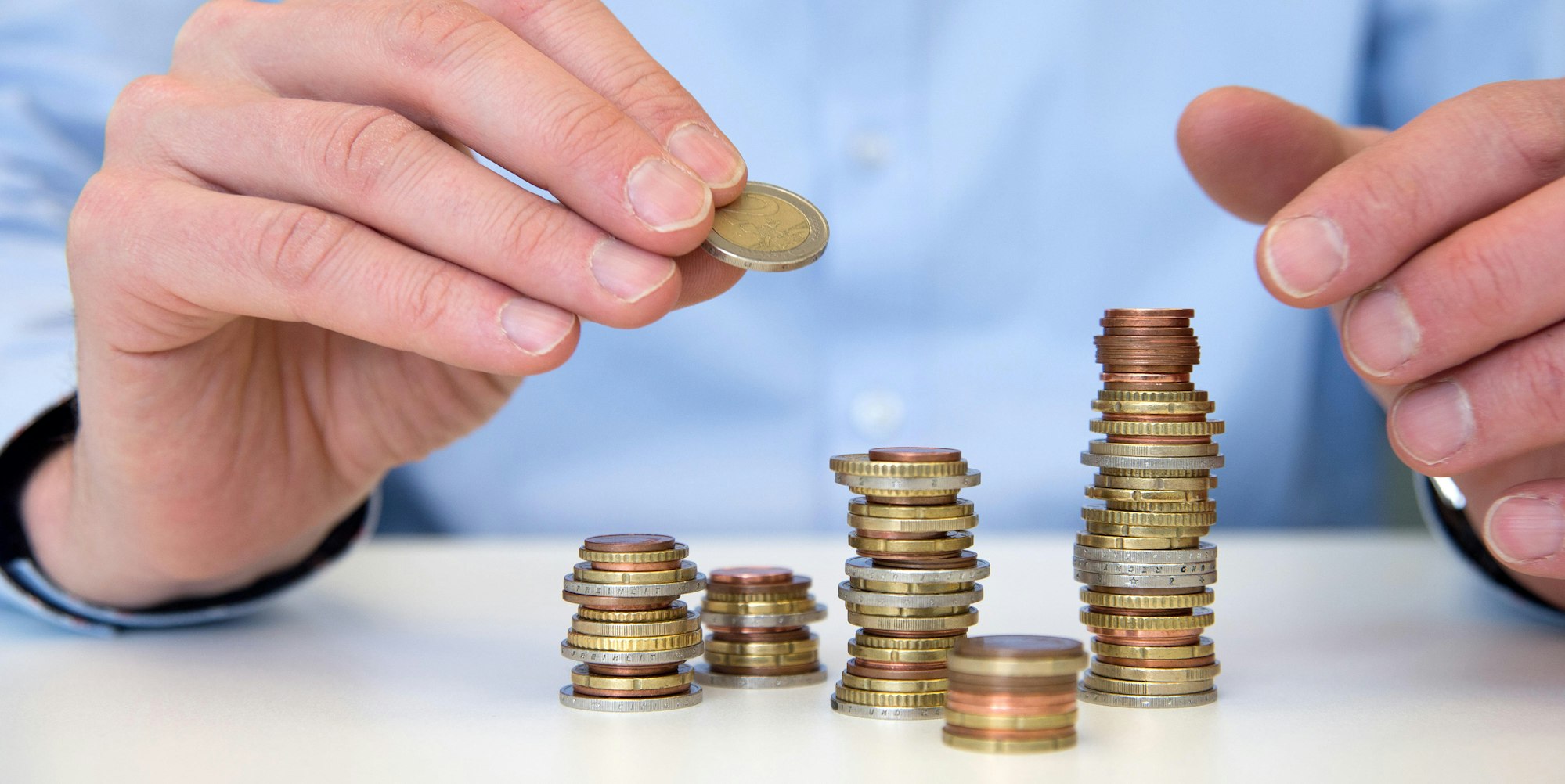 Mann baut Münztürme